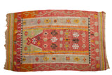Vintage Turkish Kilim prayer rug with geometric florals in faded cochineal red, orange, and saffron yellow.