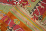 A folded corner of a vintage Turkish Kilim showing its striped back and flat-woven texture.