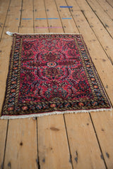Fringe and secure navy blue border with intricate floral motifs on vintage Lilihan rug.