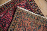 Hand-knotted fringe and secured border of this vintage Persian Lilihan rug, displaying cherry red floral motifs.