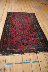 Raspberry red field with geometric vinery, sapphire blue border on a vintage Mehreban rug.