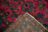 Vintage Mehreban rug with raspberry pile and geometric vinery, exposing its hand-knotted foundation.