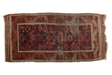 Antique Persian Belouch runner with madder red and navy geometric guls, extensive wear, 3'8