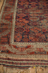 Close-up of tattered fringe, original flatwoven end, and minor border on an antique Belouch rug.