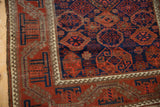 Belouch antique runner border with hook and latch motif, madder red, navy, and wear.