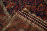 Antique Persian Belouch rug flatwoven end, showing distinct tatter and striped pattern.