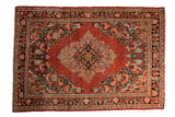 Vintage hand knotted Arak rug: cherry red field, central medallion, intricate floral spandrels.