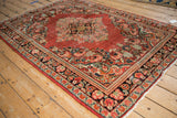 Hand-knotted Persian Arak rug corner, highlighting blush, beige floral spandrel details.