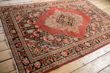 Detailed border of vintage Arak rug, featuring navy, pale cherry red floral motifs and pile texture.