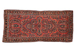 Vintage German Sarouk rug runner with allover floral bouquets on a brick red field and a navy blue main border.