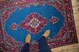 Overhead perspective of a vintage fine Kashan rug, showing the rich blue and red colors to scale.
