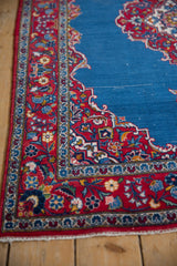 Detailed view of a vintage Kashan rug's original side cord selvage and red floral border.