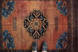 Antique Afshar rug, central stepped medallion and geometric patterns in red, navy, and sapphire.