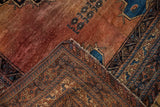 Antique Afshar rug corner showing hand-knotted foundation, multi-layered geometric borders, and wrapped selvage.