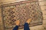 Vintage Caucasian rug with inverted coloration geometric floral guls in camel, pink, brown.
