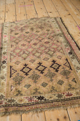 Vintage Caucasian rug with staggered guls, inverted coloration in camel, pink, and brown.