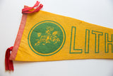 Vintage Lithuania felt flag with red sewn edge, tied tassels, and aged yellow fabric.