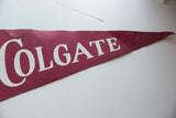 Vintage Colgate University felt pennant with white 'GATE' letters and fabric tear.