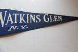 White serif lettering on the textured blue felt of a vintage Watkins Glen NY pennant.
