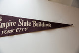 Tapered end of the vintage felt pennant with cream 'Empire State Building NEW YORK CITY' text.