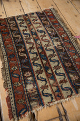 Close view of the antique Anatolian fragment's worn wool pile with parallel running water motifs.