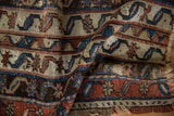 A fold in the antique Anatolian fragment reveals its high-luster wool and hand-knotted texture.