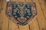 The unique contoured peak and historic low pile of an antique Persian chairback rug.