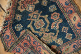 A folded corner on a collector Persian mat shows the hand knotted weave and textured pile.