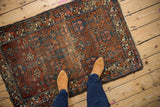 Vintage Mehreban rug with allover potted blossom design, revealing time-softened madder red pile.