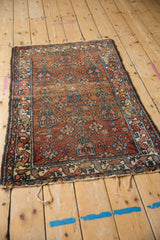 Traditional Mehreban rug corner with madder red field, powder blue blossoms, and vine border.