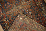 Hand-knotted weave detail with terra cotta pile and contrasting intricate beige foundation.