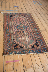 Vintage Mehreban rug corner with tattered fringe and cochineal, blue, copper tones.