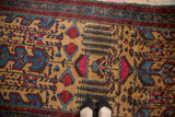 A standing view of the vintage Mehreban rug's golden field with stylized willow and pomegranate motifs.
