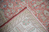 Folded corner of vintage distressed Sparta rug, showing worn blush pile and hand-knotted reverse.