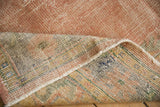Vintage Distressed Oushak carpet pile reveals foundation wear and striped woven back.