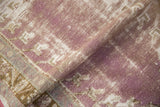 Distressed Oushak rug detail, showing pale violet, oxidized silver, and worn pile.