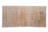 Vintage distressed Oushak rug runner with oversized medallions in dusty rose, tangerine orange, and ivory.