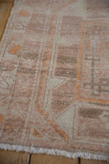 Low pile of a distressed Oushak runner showing even wear across the knot heads.