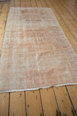 Even wear and heavy color variation along the length of a distressed Oushak runner.
