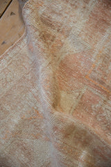 Close-up of the vintage Oushak runner's evenly worn pile and intact side cord selvage.
