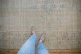 Distressed vintage Oushak carpet with soft textured pile and faded pale blue motifs.