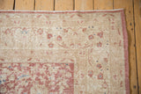 Distressed vintage Turkish Sparta carpet corner; faded pink palmette vinery, textured ivory pile.