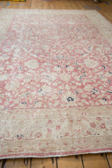 Textured surface of the distressed Sparta carpet with pink floral vinery and palmettes.