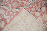 Distressed cochineal pink floral pattern with woven foundation and pink selvage.