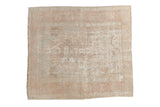 Distressed vintage Oushak square rug, faded ivory and blush floral, with visible wear. 3'7