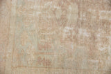 Distressed vintage Oushak rug showing worn knot heads and visible foundation.