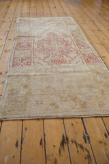 Distressed texture and secured end of a vintage Oushak rug runner.