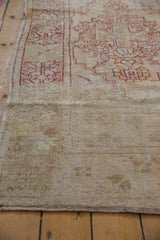 Distressed vintage Oushak runner showing low pile, cherry red patterns, and side cord selvage.