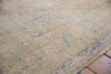 Distressed Oushak rug texture revealing worn pile, foundation, beige, and faded blue.