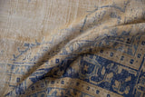 Distressed Oushak carpet pile showing textural abrash and cobalt blue border pattern.